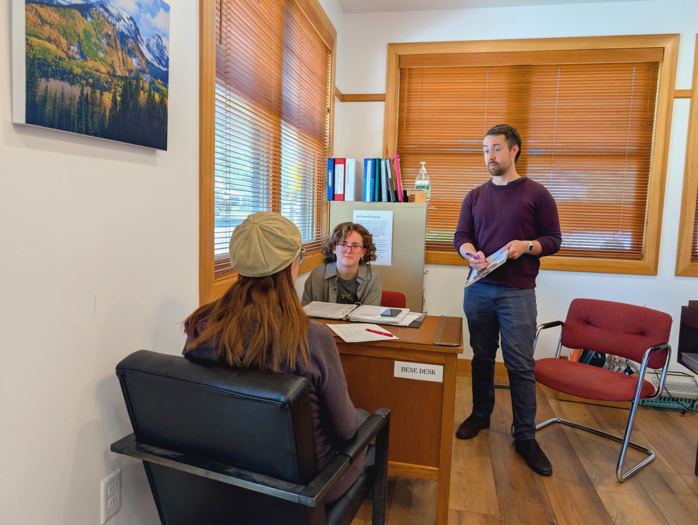 Two JCFC members advocating for another member across a desk.